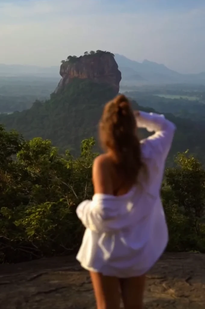 Woman looking sigiriya rock from the pidurangala 